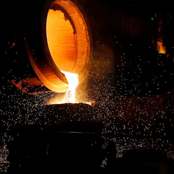 Rolled metal stock stacked in an industrial facility