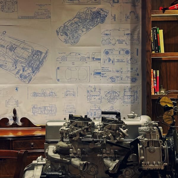 Engineering drawings and measuring tools on a bench